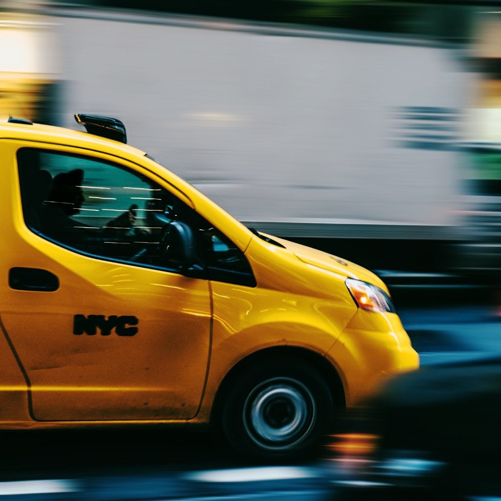A taxi rushes through the streets of New York City
