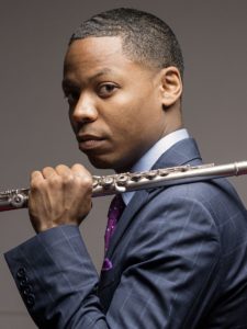 Portrait of flautist Brandon Patrick George holding his flute